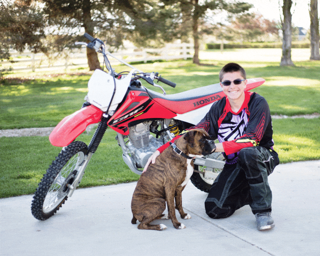 boy with motorcycle and dog