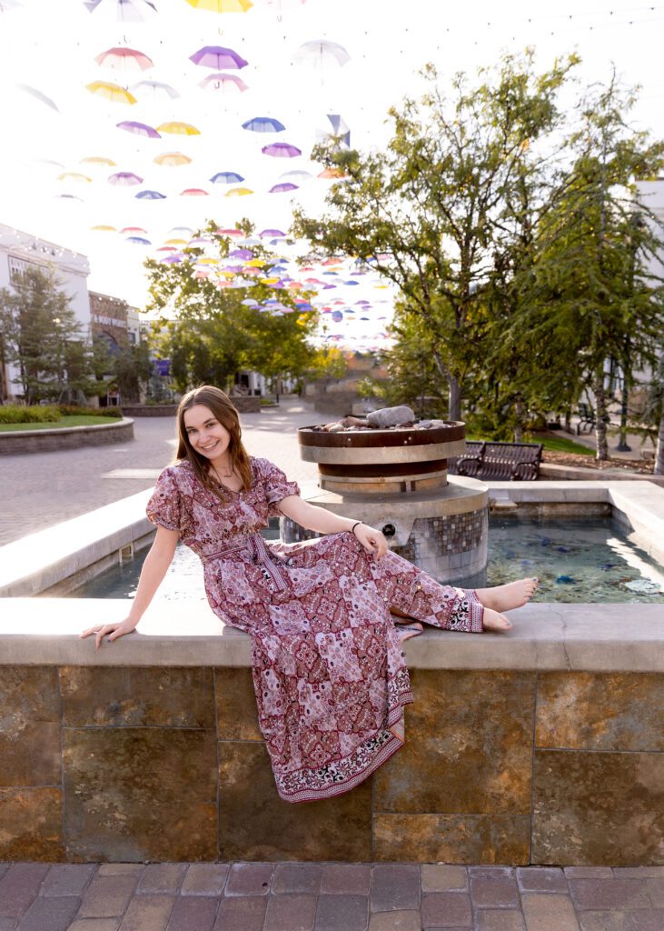 girl posing near fountain