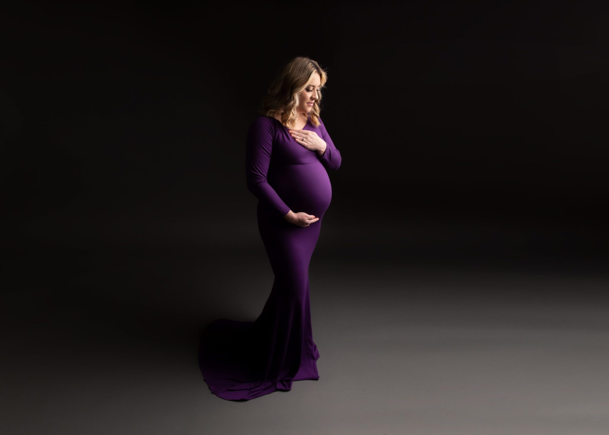 mom in purple dress that is part of her utah maternity package