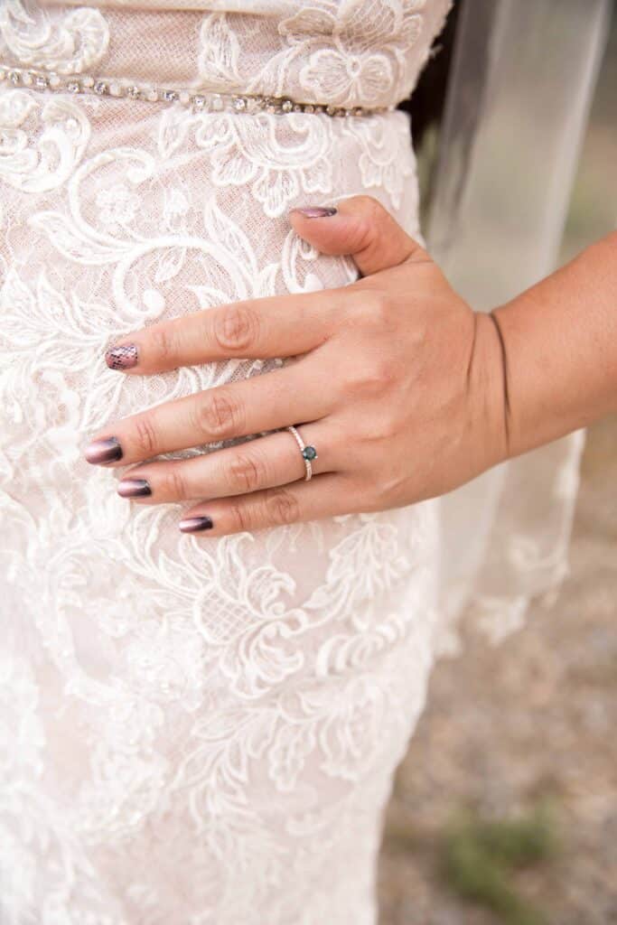 close up wedding ring and dress