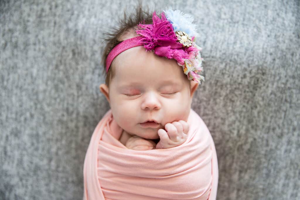 baby with pink bow provo newborn portraits