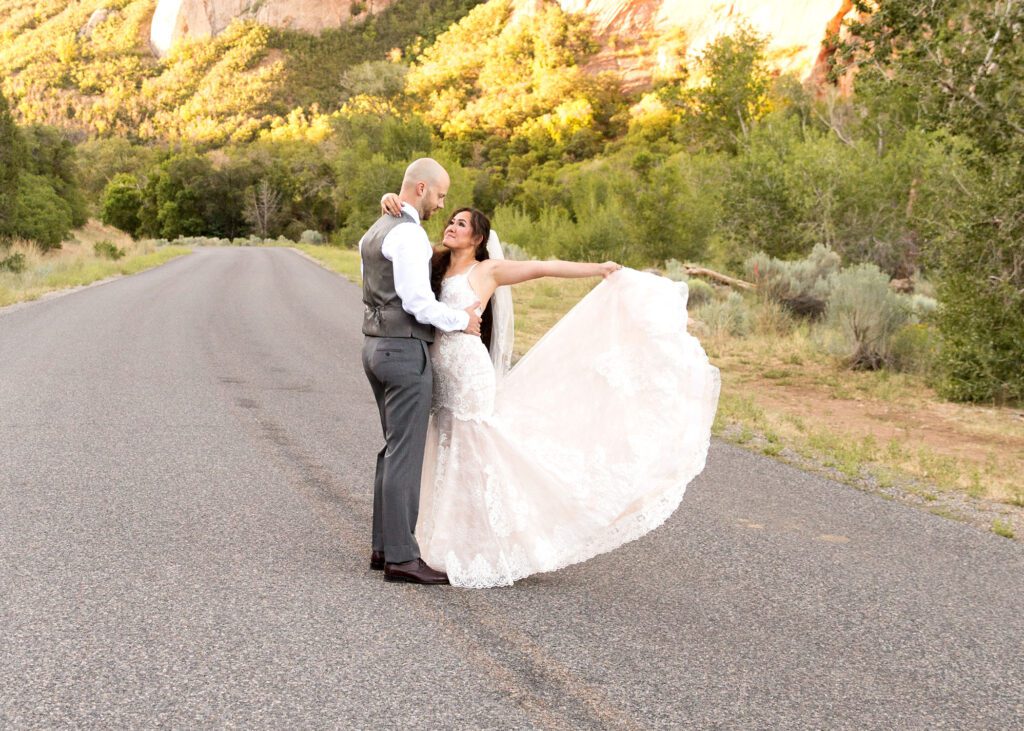 bride twirling dress in road