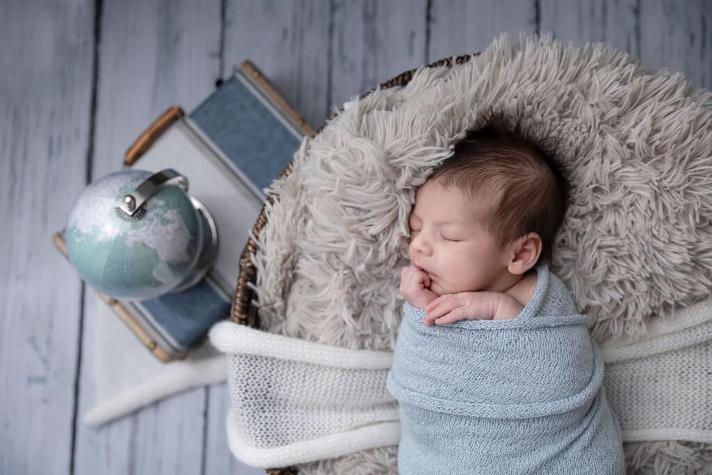 baby with globe and suitcase provo newborn portraits