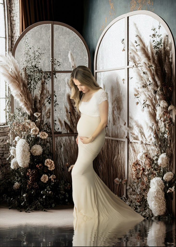 white gown maternity portrait in boho background white lace and tan dress