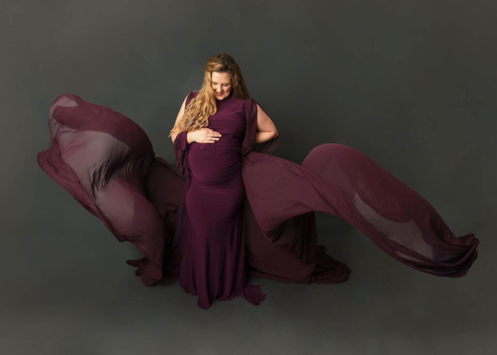 woman wearing flowing purple maternity gown