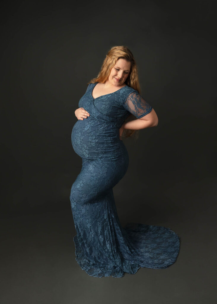 woman wearing blue lace maternity gown