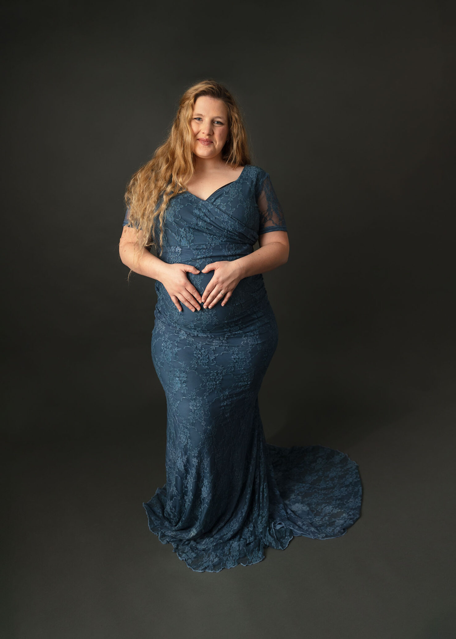 woman wearing blue lace maternity gown