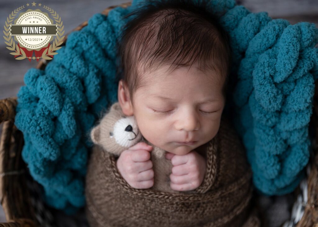 utah county newborn photographer award winning photo of baby boy holding a teddy bear