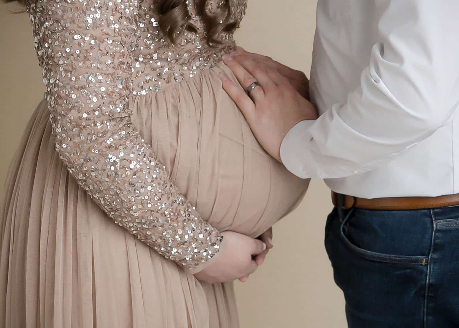 mom and dad holding baby bump maternity photo