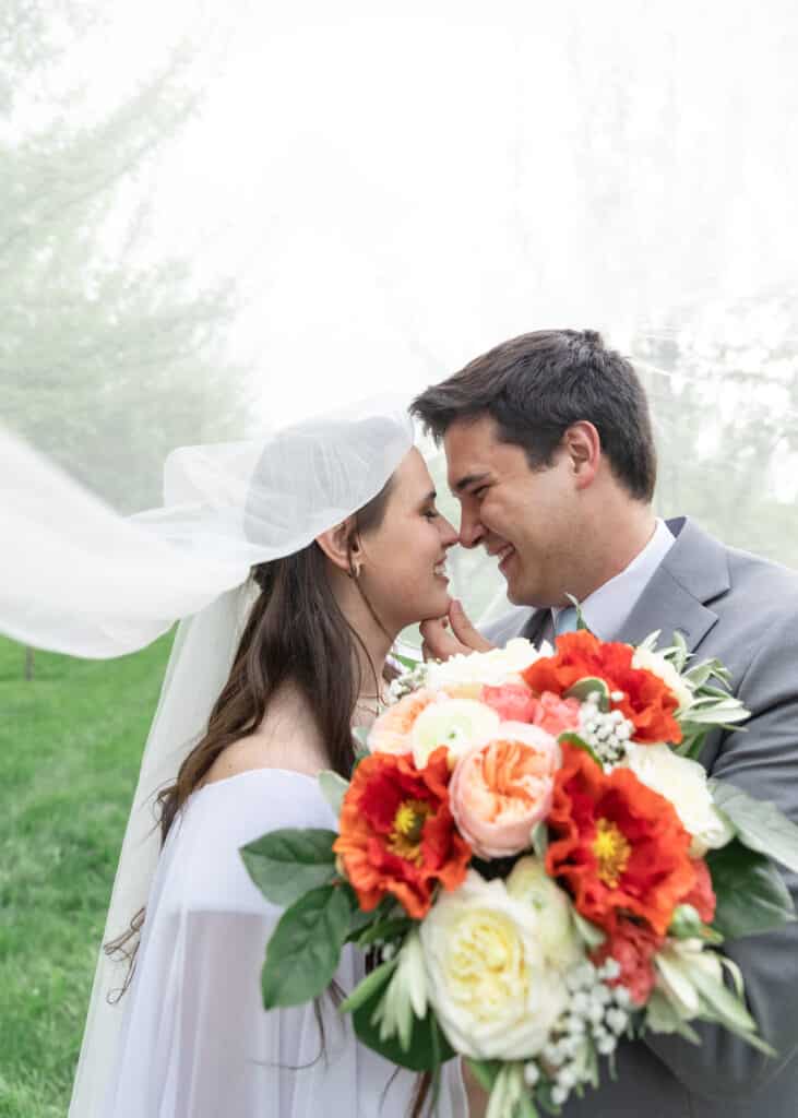 bride and groom under veil