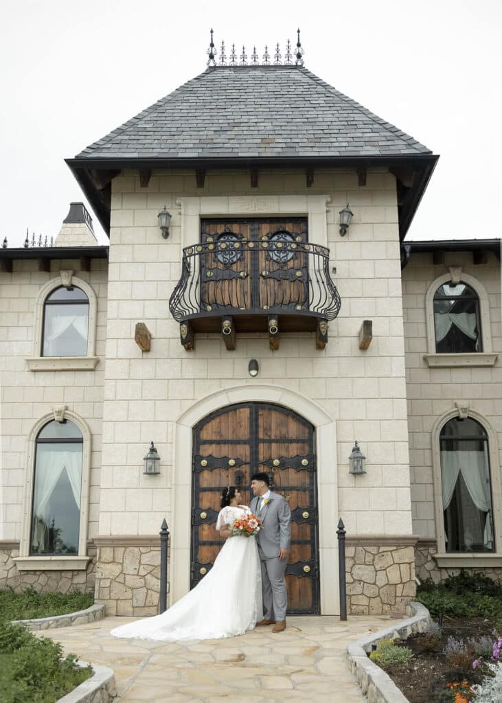 bride and groom in front of wooden doors
