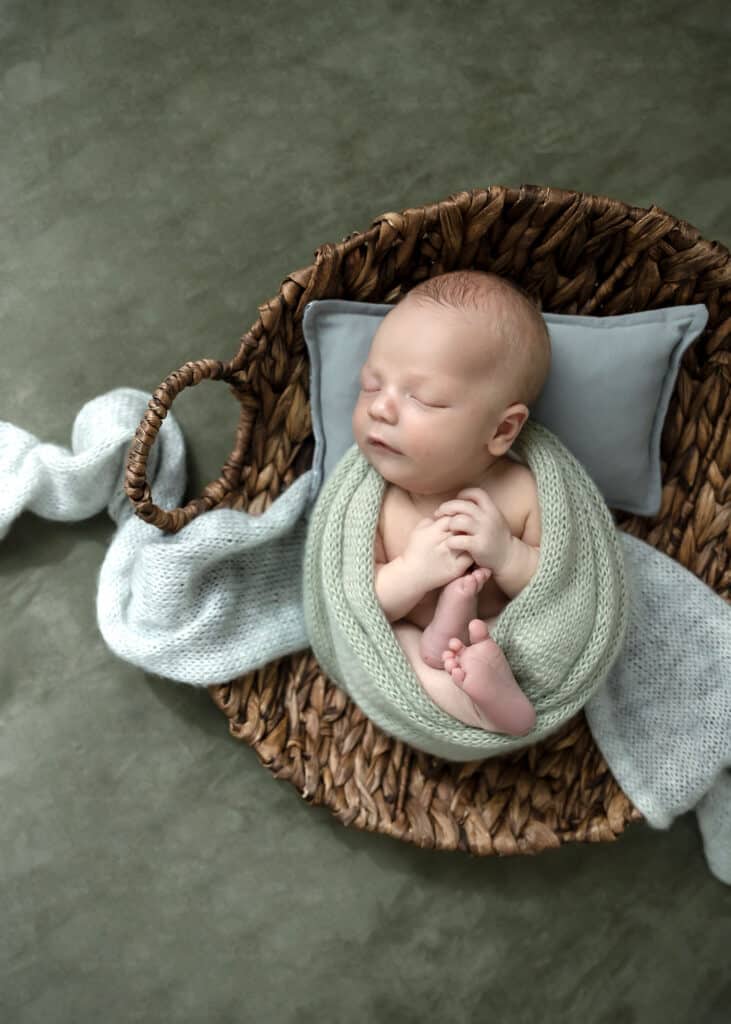 baby boy in green wrap utah county newborn studio