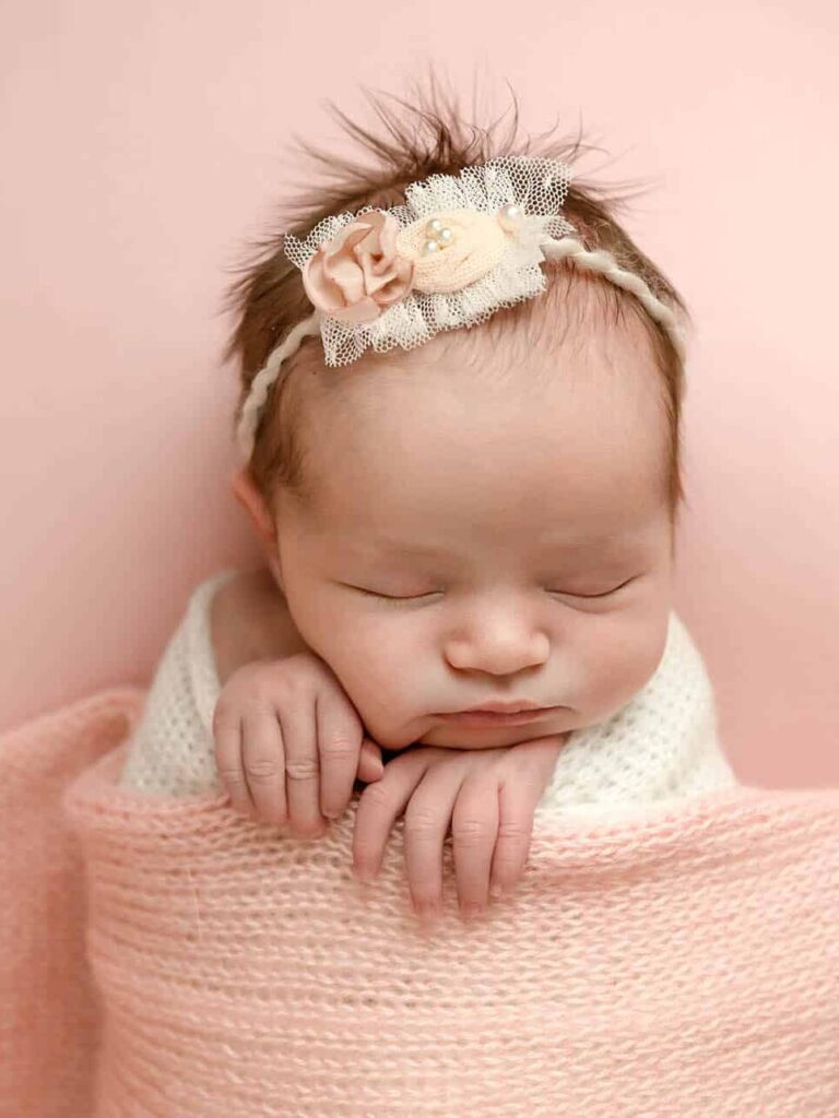 baby girl with pink blanket picture taken by a Utah newborn photography package