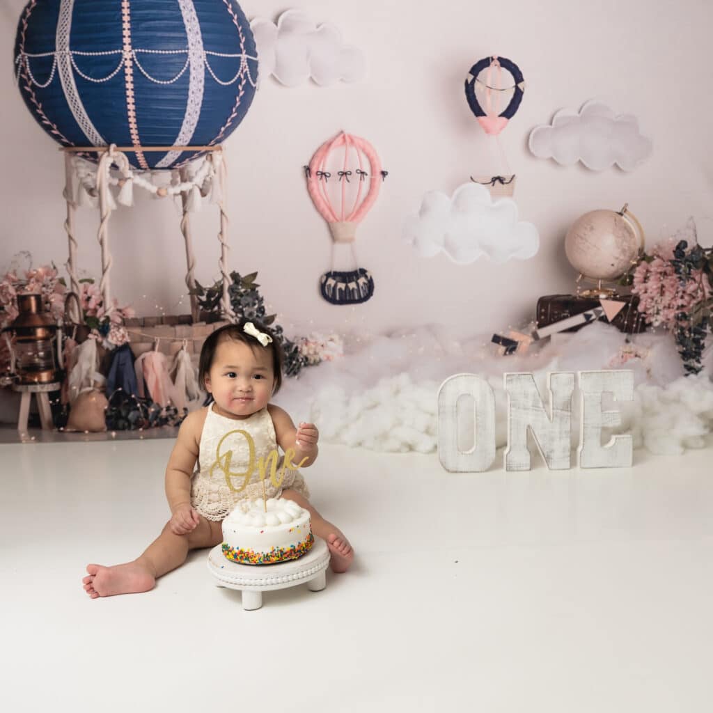 girls hot air balloon cake smash session blue and pink hot air balloons