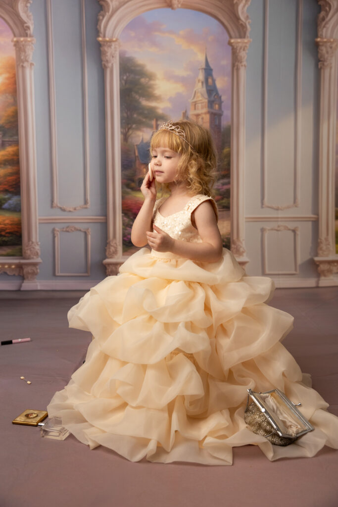 girl doing makeup during a princess mini session